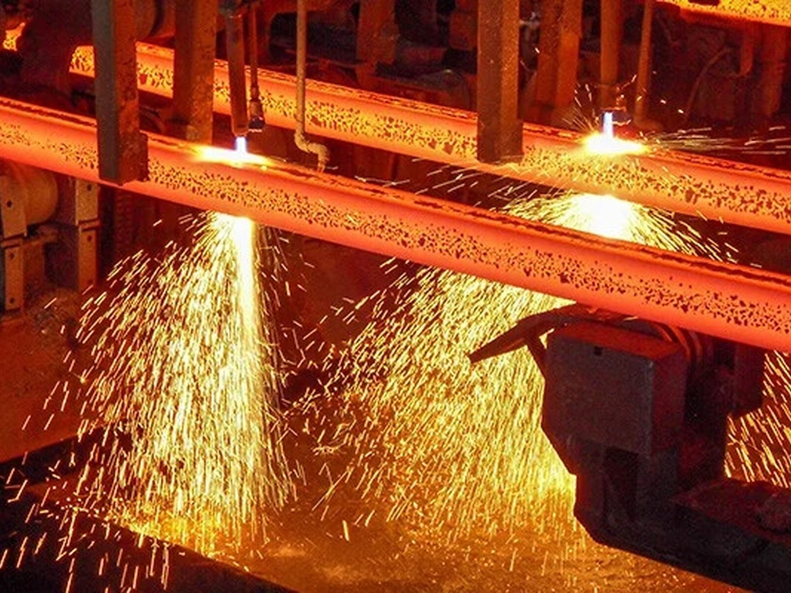 Hot steel billet being cut on a rolling mill